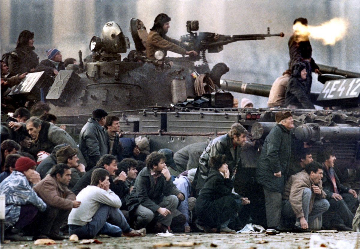 bucharests-residents-protect-themselves-from-the-crossfire-during-clashes-in-the-republican-square-in-bucharest-december-1989