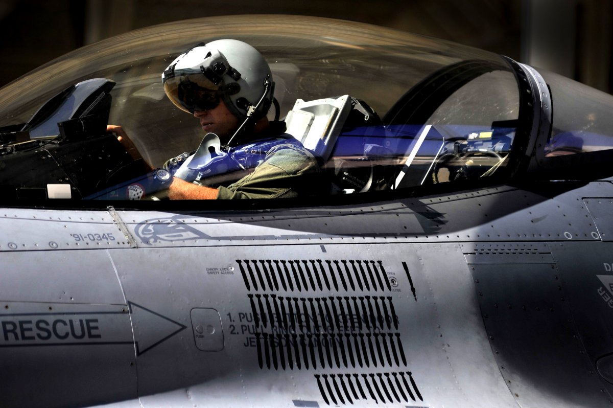 a-us-air-force-f-16-fighting-falcon-pilot-with-the-77th-fighter-squadron-fs-settles-into-his-cockpit-before-takeoff-october-5-2011-from-shaw-air-force-base
